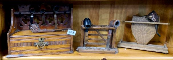 Three smokers pipe racks and a group of good tobacco pipes.