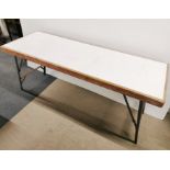 A heavy folding workman's table, 178 x 62cm.