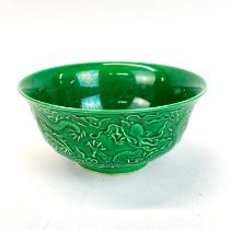 A Chinese green glazed porcelain bowl, relief decorated with dragons, H. 7cm, Dia. 15cm.