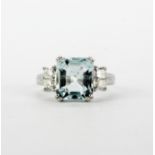An 18ct white gold ring set with a large emerald cut aquamarine, approx. 3.48ct, and princess cut