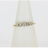 A hallmarked 9ct yellow gold ring set with graduated brilliant cut diamonds, (N).