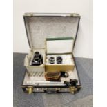 A Mamiya C330 twin lens reflex camera with additional lenses, tri-pod and carrying case.