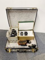 A Mamiya C330 twin lens reflex camera with additional lenses, tri-pod and carrying case.