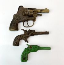 Three early replica/ toy guns, largest 14cm.