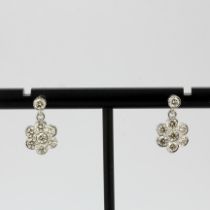 A pair of 18ct white gold flower shaped drop earrings set with brilliant cut diamonds, total approx.