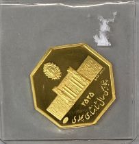 An Iranian hexagonal gold coin for Bank Melli, W. 2cm.