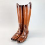 A composition umbrella stand in the form of a pair of riding boots, H. 47cm.