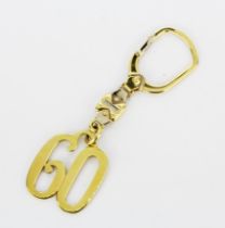 A hallmarked 18ct yellow gold '60' keyring, L. 9.5cm.