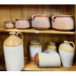 A quantity of terracotta kitchen pots and stoneware jars.