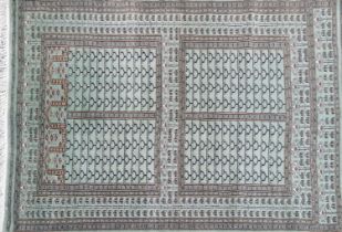 A green ground Eastern wool rug, 178 x 115cm.