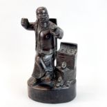 A Chinese carved hardwood figure of a money lender, H. 35cm.