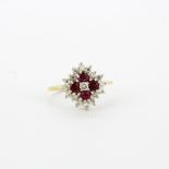 A hallmarked 18ct yellow gold cluster ring set with round cut rubies and brilliant cut diamonds, (