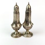 A pair of sterling silver salt and pepper pots, H. 13cm.