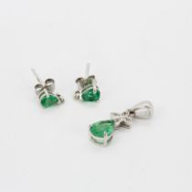 A pair of 925 silver stud earrings set with a pear cut green tourmaline and clear quartz, together