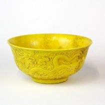 A Chinese relief decorated yellow glazed porcelain bowl, Dia. 15cm, H. 7cm.