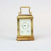 A small brass carriage clock with an enamelled dial and day and date functions, H. 10cm.