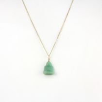 A nephrite jade Buddha pendant mounted on a 14ct (stamped 14k) bail, with a 9ct yellow gold chain (
