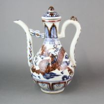 A Chinese hand painted porcelain wine jug with underglaze blue and red decoration of a dragon.