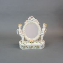 A continental porcelain cherub mirror, H.28cm.