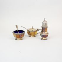 A heavy hallmarked silver three piece cruet set, sugar shaker H. 11.5cm.