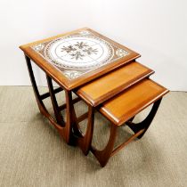 A nest of three G Plan style 1970's teak tables, largest table inset with tiles, 51 x 50 x 50cm.