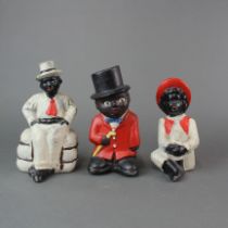 Three painted cast iron money boxes, Tallest H. 19cm.