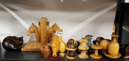 A pair of carved wooden book ends with a further group of wooden items.