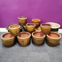 A group of thirteen mixed ceramic plant pots including glazed and stone inset pots, largest H.