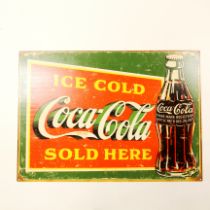 A reproduction Coca Cola advertising sign, 50 x 70cm.