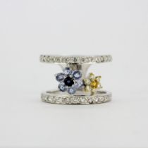 A heavy 18ct white gold ring set with diamonds, fancy yellow diamonds and sapphires, (O).