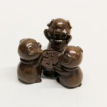 An amusing Chinese bronze figure of three pigs playing Mah Jong, W. 7cm, H. 4.5cm.