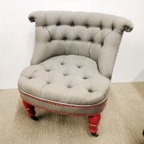 A re-upholstered button backed nursing chair with turned wooden painted legs, H. 70cm.