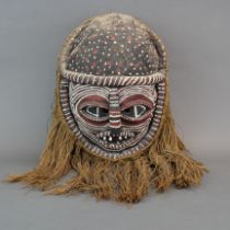 A large bamboo and jute painted tribal mask, H. 63cm.