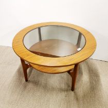 A two tier teak veneered Schreiber circular coffee table with smoked glass top, Dia. 84cm H. 45cm.