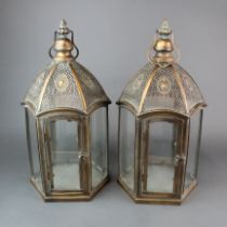 A pair of bronzed finish metal and glass storn lanterns, H. 50cm.