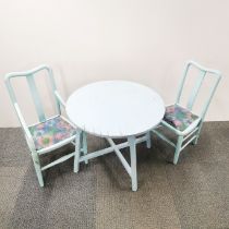A painted child's table and two chairs, table H. 51cm Dia. 63cm.
