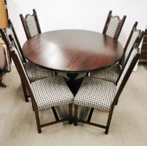 An oak pedestal dining table together with a set of six oak and upholstered dining chairs, H. 75cm