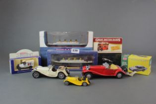 A group of mixed diecast metal models of ships and motor cars.