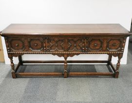 An early 20th C carved oak sideboard with cast iron handles 195 x 83 x 54cm.