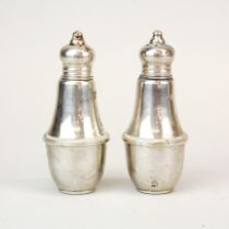 A pair of Dunchin creations weighted sterling silver salt and pepper pots, H. 10cm.