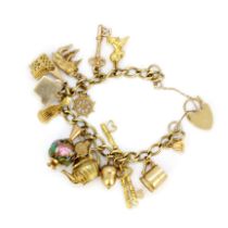 A hallmarked 9ct yellow gold charm bracelet with 9ct and yellow metal charms.