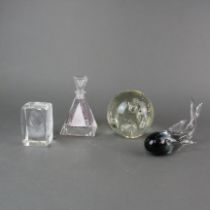 Three glass paper weights and a perfume bottle, tallest 12cm.