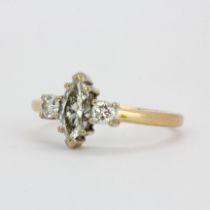 A hallmarked 18ct yellow and white gold ring, set with a marquise cut centre diamond (approx. 0.