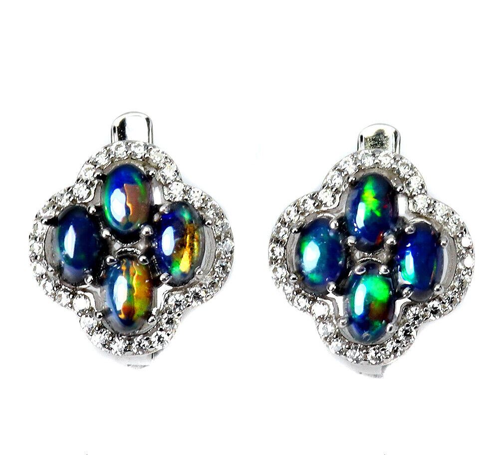 A matching pair of 925 silver earrings set with cabochon cut black opals and white stones, L. 1.