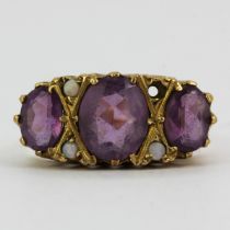 A hallmarked 9ct yellow gold (worn hallmark) ring set with large amethysts and opals, (Q). One