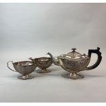 An Indian three piece silver tea set stamped sterling silver. Spout to handle 30cms.