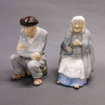 A pair of Irish porcelain figures of an elderly couple, H. 20cm. One is A/F to nose.