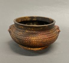 A Chinese bronze censer with basket weave decoration and four character stamp to base, Dia. 16cm.