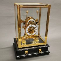 A brass and glass cased grasshopper clock. Case size 24 x 20 x 14cm.