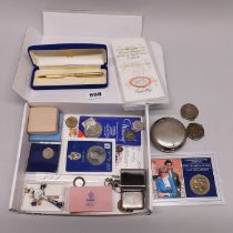 A box of mixed coins and other items.